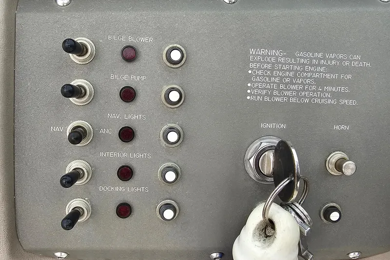 Slide: The Image of Control panel of a 2003 Cobalt 220 boat with switches and ignition key. - 12