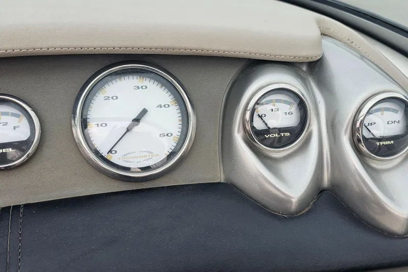Slide: The Image of Dashboard of a 2003 Cobalt 220 boat with tachometer and voltmeter gauges. - 14