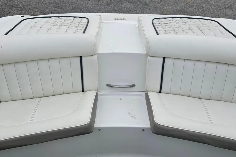 Slide: The Image of White interior seating of a 2003 Cobalt 220 boat, featuring cushioned upholstery. - 16