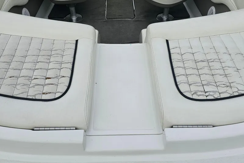 Slide: The Image of Interior of a 2003 Cobalt 220 boat with worn white seating. - 17