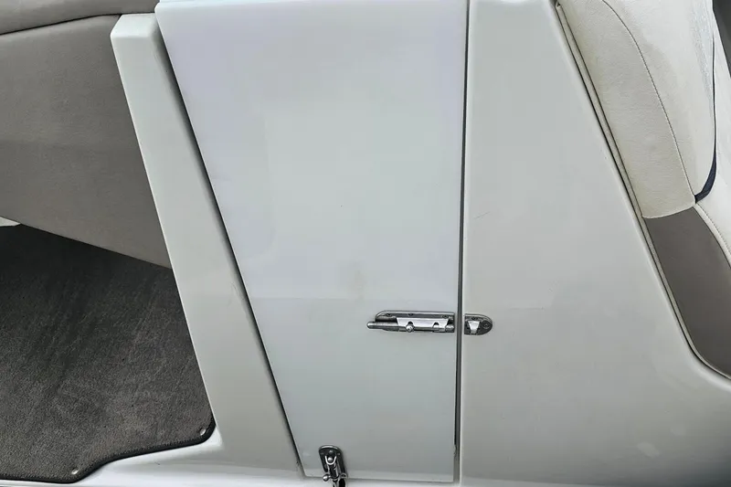 Slide: The Image of 2003 Cobalt 220 boat interior, featuring a sleek white panel and comfortable seating. - 18