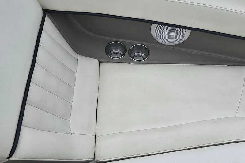 Slide: The Image of Interior of a 2003 Cobalt 220 boat with white seating and cup holders. - 5