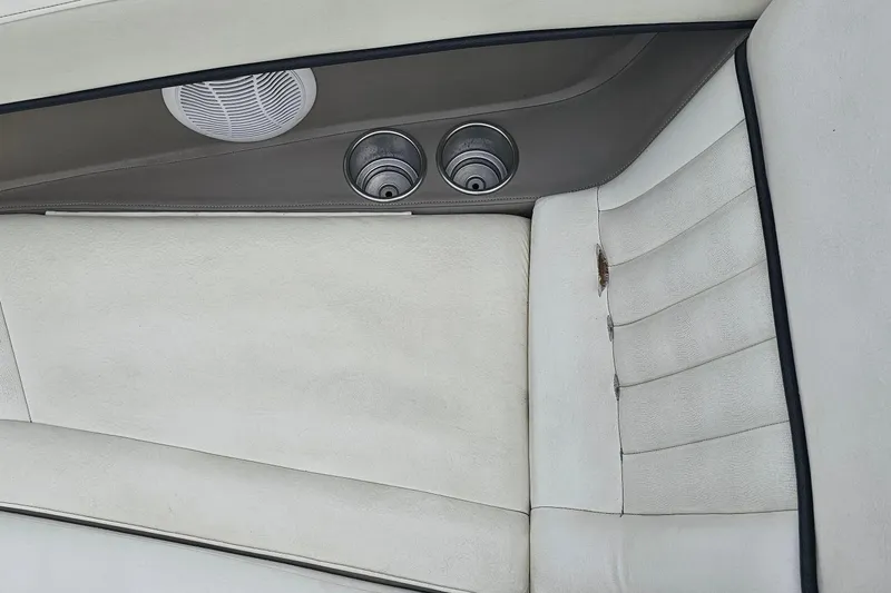 Slide: The Image of Interior of a 2003 Cobalt 220 boat with white upholstery and cup holders. - 6