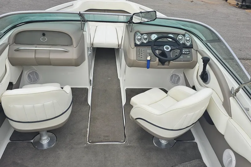Slide: The Image of Interior of a 2003 Cobalt 220 boat with white seating and dashboard controls. - 7