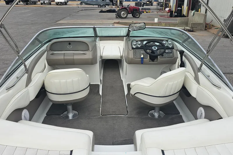Slide: The Image of Interior of a 2003 Cobalt 220 boat with white seating and dashboard. - 8