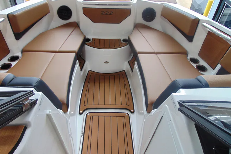 Slide: The Image of 2026 Yamaha Boats 222SD interior with tan seating and wood-style flooring. - 10