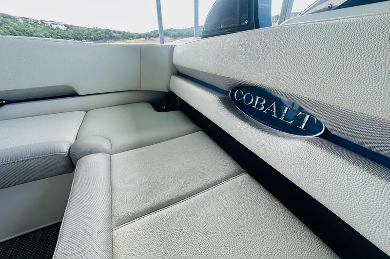 Slide: The Image of Interior of 2018 Cobalt CS23 Surf boat with gray seating and logo. - 17