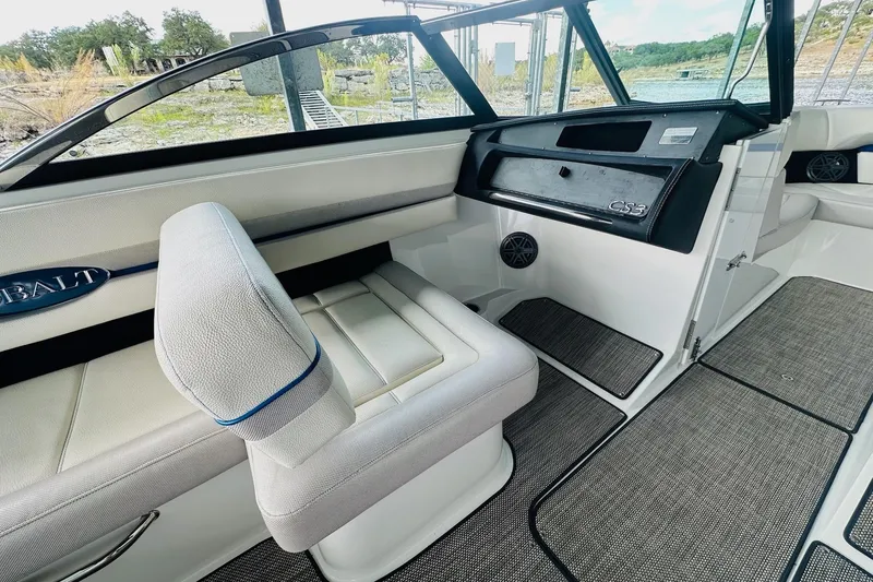 Slide: The Image of 2018 Cobalt CS23 Surf boat interior with white seating and dashboard. - 19
