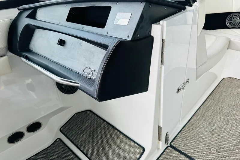 Slide: The Image of 2018 Cobalt CS23 Surf boat interior with glove compartment and seating area. - 20