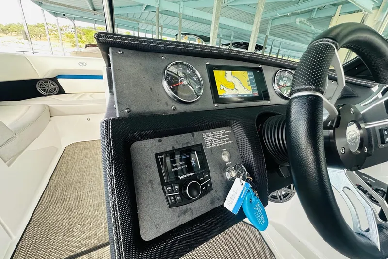 Slide: The Image of Interior dashboard of a 2018 Cobalt CS23 Surf boat with navigation display and controls. - 22