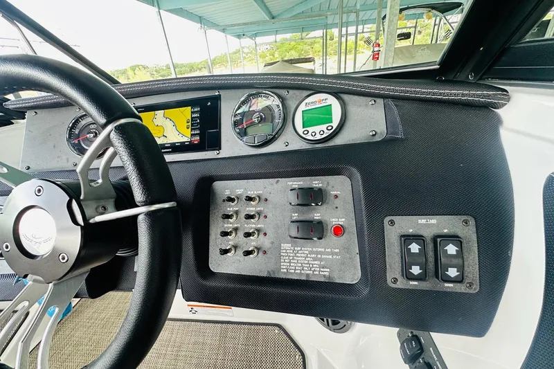 Slide: The Image of 2018 Cobalt CS23 Surf dashboard with steering wheel, gauges, and control panel. - 23