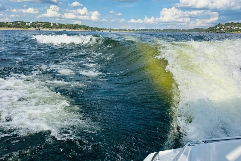 Slide: The Image of Wake created by a 2018 Cobalt CS23 Surf boat on a sunny day. - 26