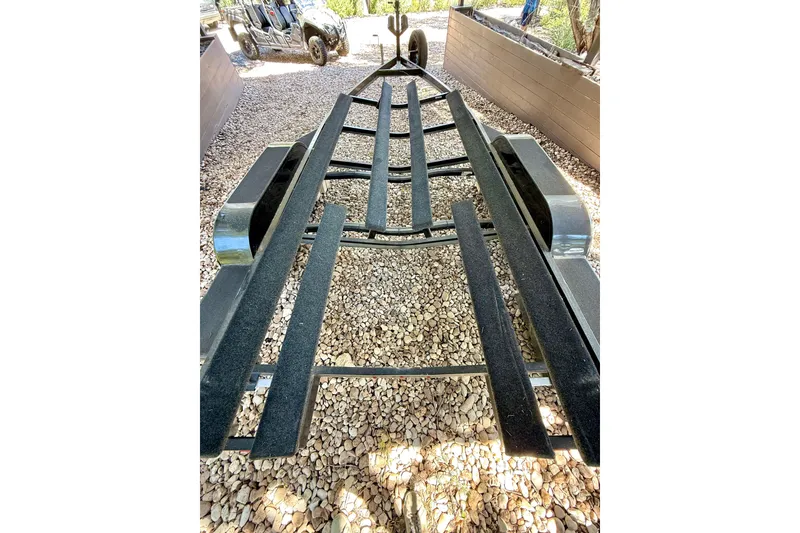 Slide: The Image of Trailer for 2018 Cobalt CS23 Surf boat on gravel driveway. - 32