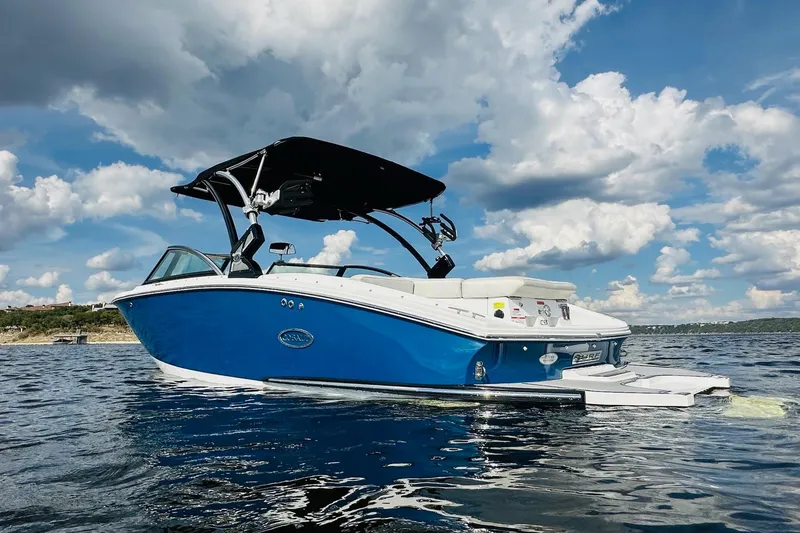 Slide: The Image of 2018 Cobalt CS23 Surf boat on water under a cloudy sky. - 5