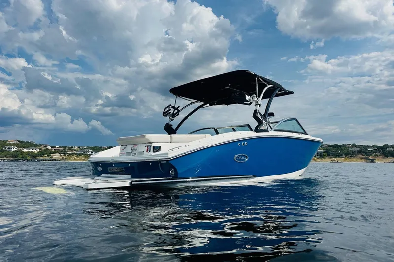 Slide: The Image of 2018 Cobalt CS23 Surf boat on water under cloudy sky. - 7