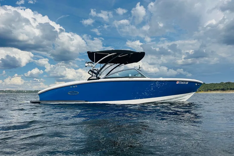 Slide: The Image of 2018 Cobalt CS23 Surf boat on water under cloudy sky. - 8