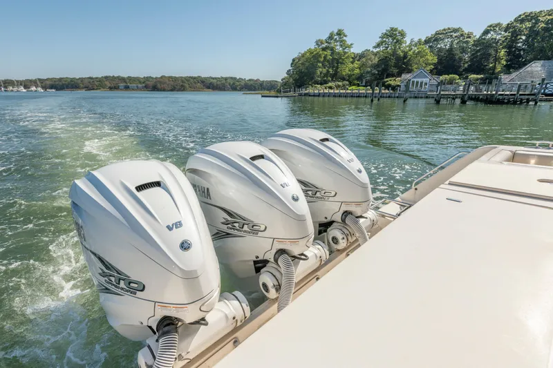 Slide: The Image of 2019 Grady-White Freedom 375 boat with triple Yamaha outboard engines on a scenic waterway. - 11