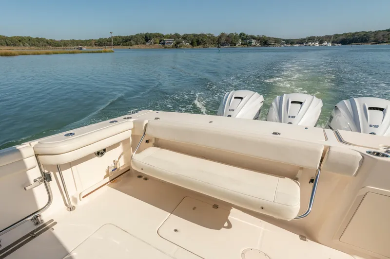 Slide: The Image of 2019 Grady-White Freedom 375 boat with triple V8 engines on a serene waterway. - 13