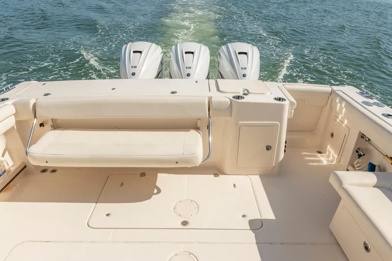 Slide: The Image of 2019 Grady-White Freedom 375 boat with triple V8 engines on open water. - 14