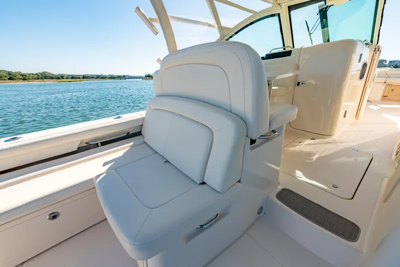 Slide: The Image of Luxurious interior of 2019 Grady-White Freedom 375 boat with plush seating and scenic water view. - 17
