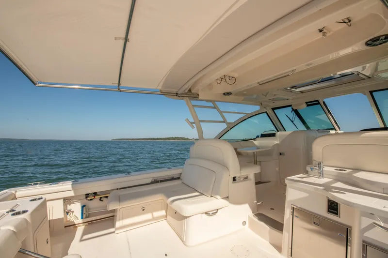 Slide: The Image of 2019 Grady-White Freedom 375 boat interior with luxurious seating and ocean view. - 19