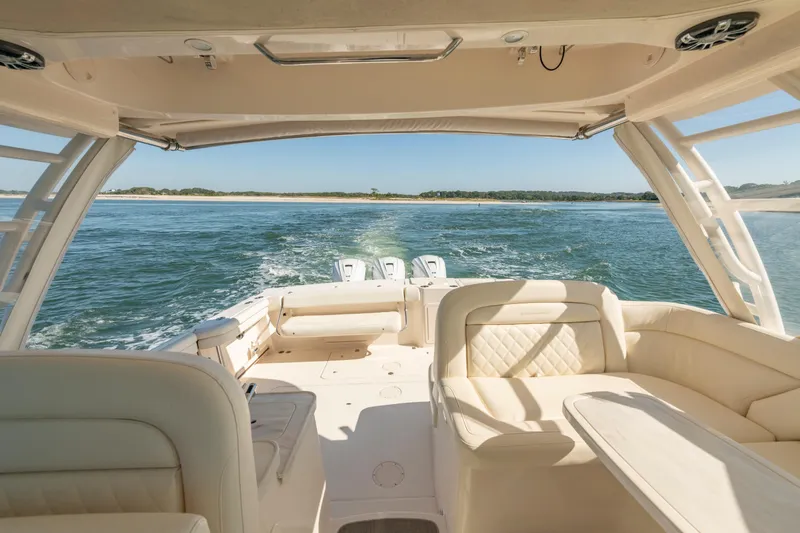 Slide: The Image of 2019 Grady-White Freedom 375 boat interior with ocean view, featuring luxurious seating. - 21