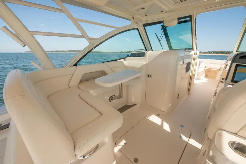 Slide: The Image of 2019 Grady-White Freedom 375 boat interior with luxurious seating and ocean view. - 23