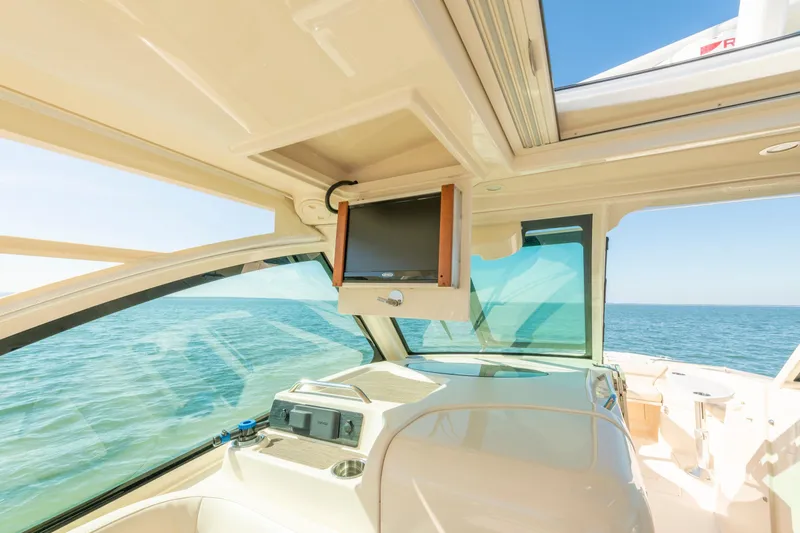 Slide: The Image of 2019 Grady-White Freedom 375 boat interior with ocean view and mounted screen. - 24