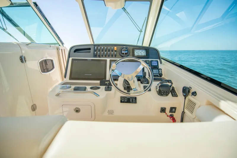 Slide: The Image of 2019 Grady-White Freedom 375 boat helm with modern navigation controls and ocean view. - 26