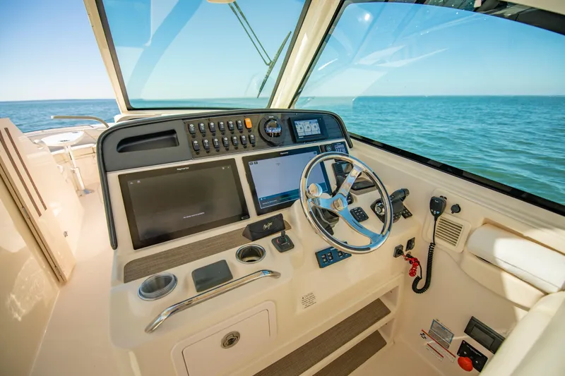 Slide: The Image of 2019 Grady-White Freedom 375 helm with modern controls and ocean view. - 27