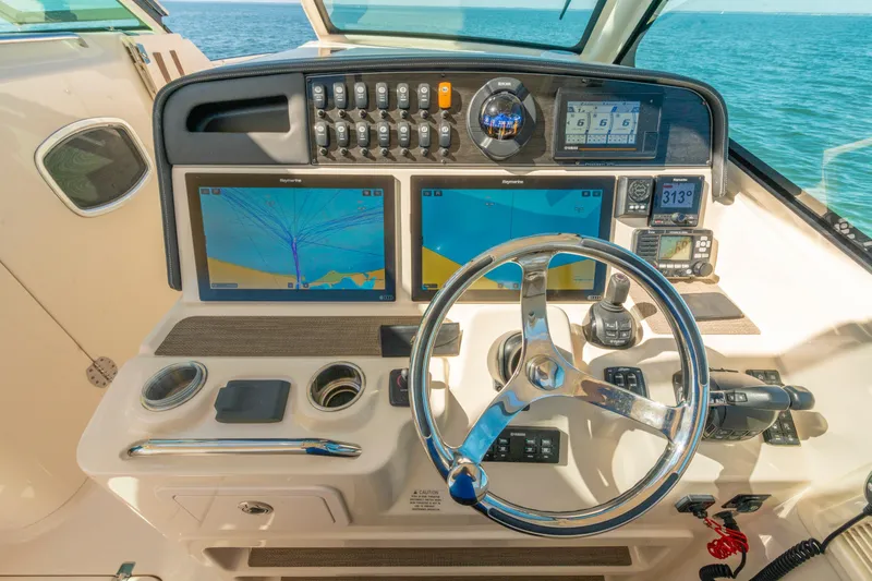 Slide: The Image of 2019 Grady-White Freedom 375 helm with dual navigation screens and steering wheel. - 28