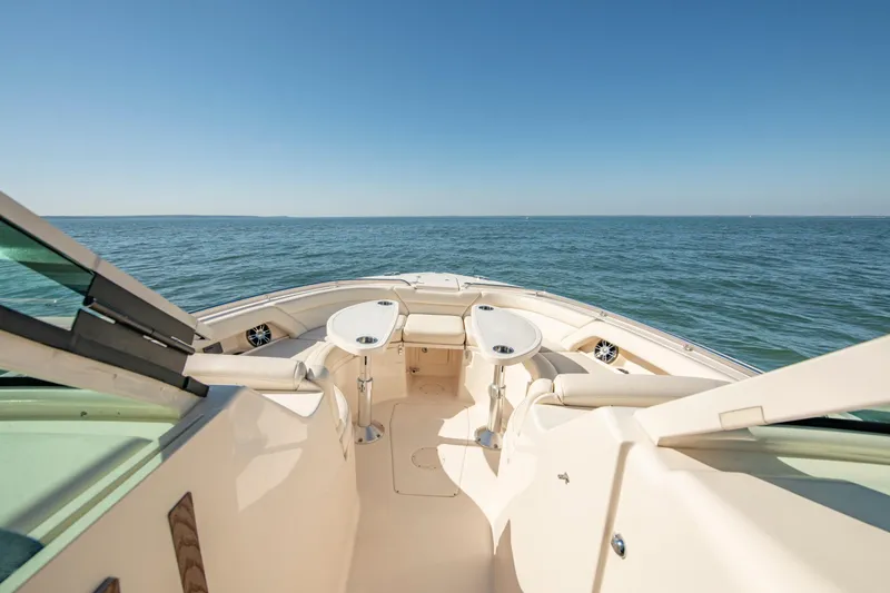 Slide: The Image of 2019 Grady-White Freedom 375 boat on open water, featuring spacious seating and tables. - 29
