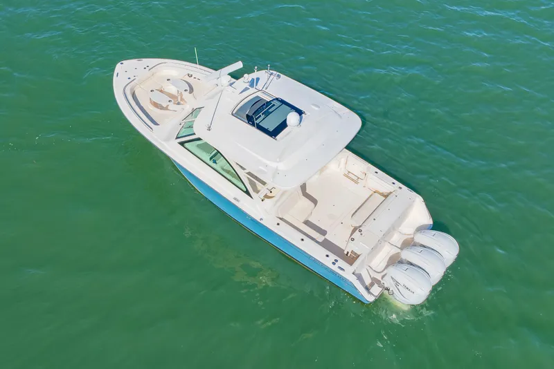 Slide: The Image of 2019 Grady-White Freedom 375 boat on clear green water, aerial view. - 3