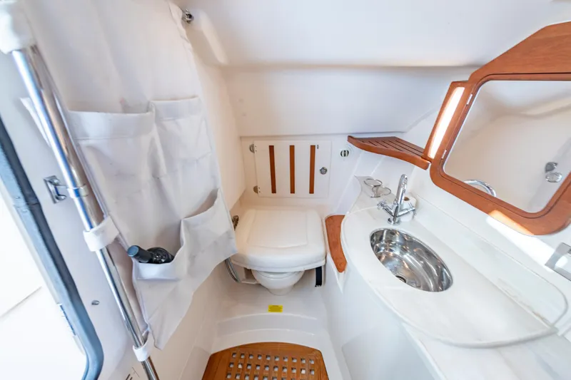 Slide: The Image of 2019 Grady-White Freedom 375 boat bathroom with sink, mirror, and storage. - 33