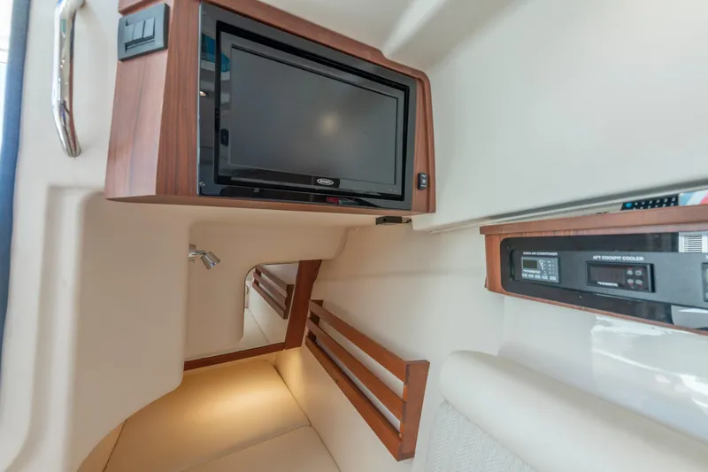 Slide: The Image of 2019 Grady-White Freedom 375 cabin interior with TV and control panel. - 39