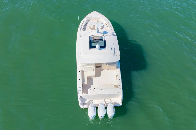 Slide: The Image of Aerial view of 2019 Grady-White Freedom 375 boat on green water. - 4