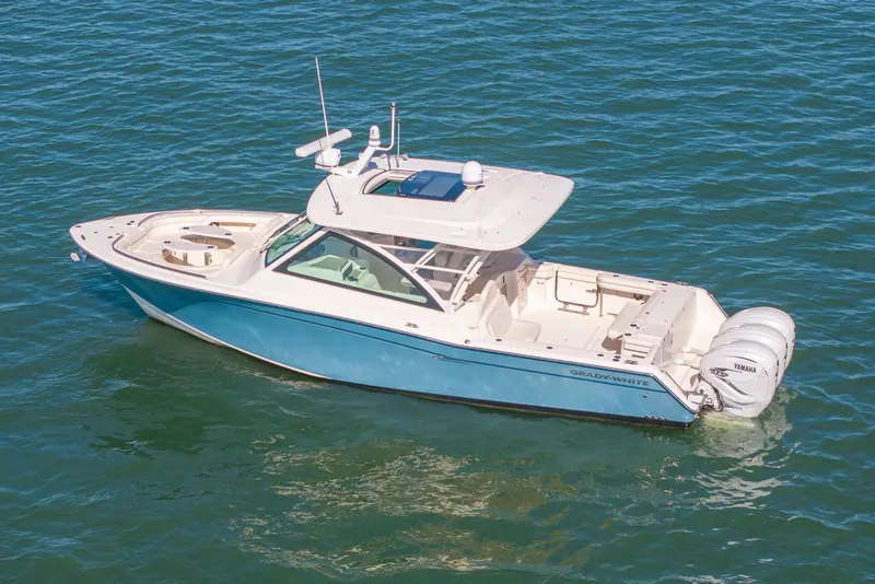 Slide: The Image of 2019 Grady-White Freedom 375 boat on open water, featuring dual Yamaha engines. - 6
