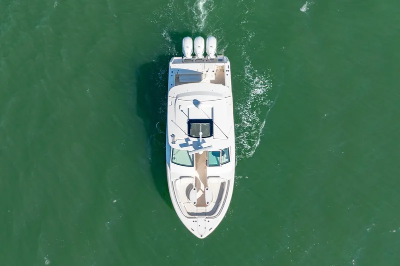 Slide: The Image of Aerial view of 2019 Grady-White Freedom 375 boat cruising on green water. - 7