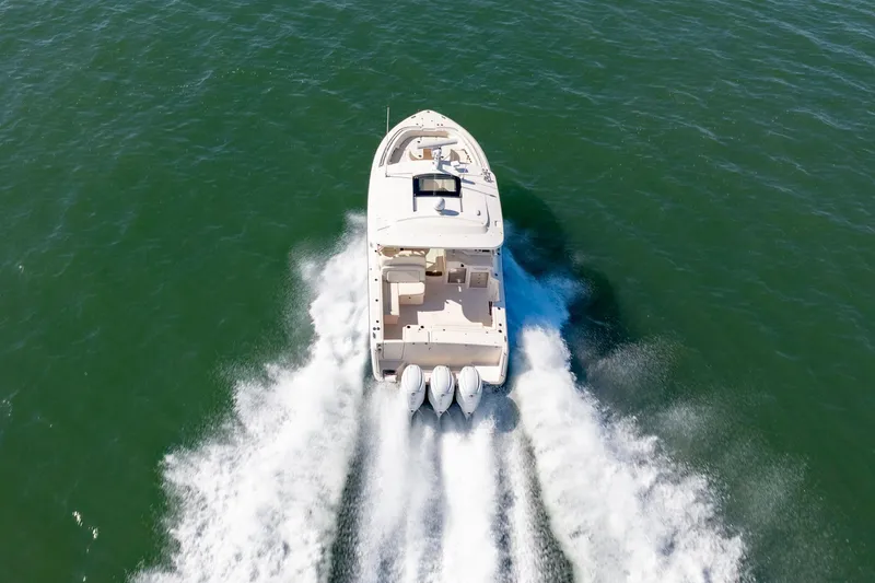 Slide: The Image of 2019 Grady-White Freedom 375 boat cruising on open water, rear view. - 8
