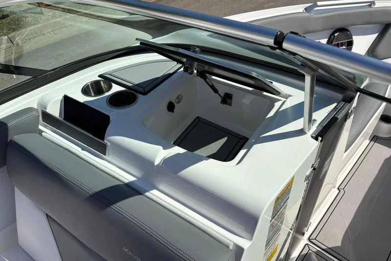 Slide: The Image of 2019 MasterCraft boat interior with cup holders and storage compartment. - 10