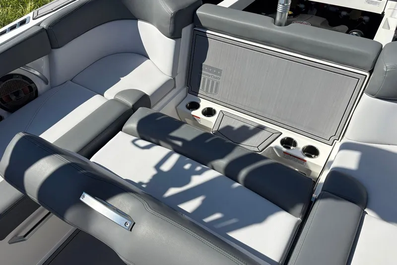 Slide: The Image of 2019 MasterCraft boat interior with gray seating and cup holders. - 12