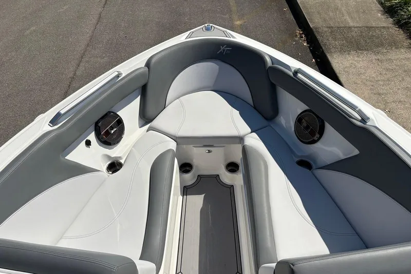 Slide: The Image of 2019 MasterCraft boat interior with gray and white seating, featuring built-in speakers. - 13