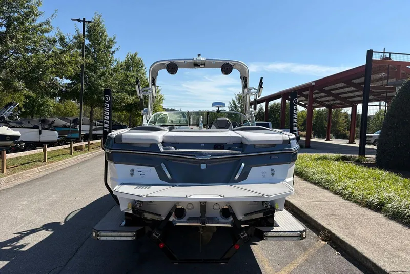 Slide: The Image of 2019 MasterCraft boat parked outdoors on a sunny day, rear view. - 4