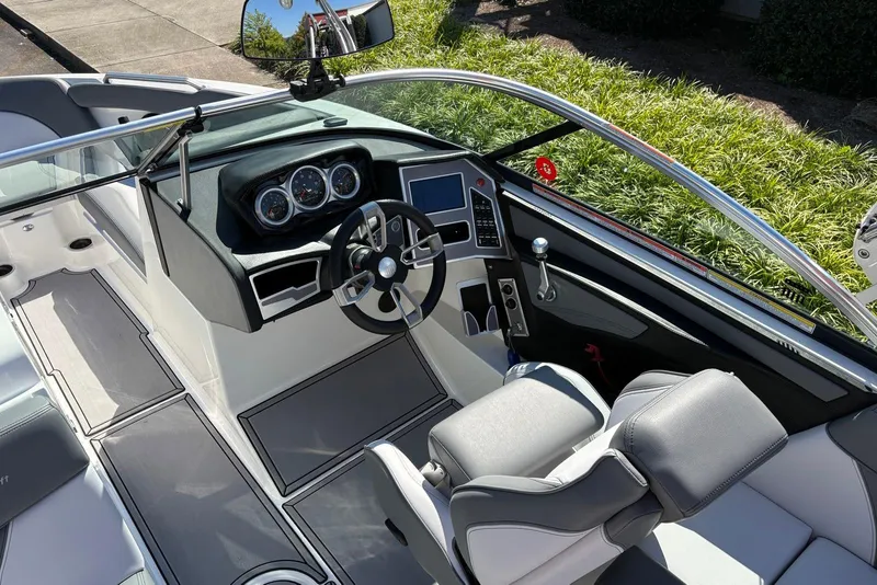 Slide: The Image of 2019 MasterCraft boat interior with sleek dashboard, steering wheel, and comfortable seating. - 5