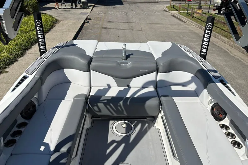 Slide: The Image of 2019 MasterCraft boat interior with gray and white seating, cup holders, and speakers. - 6