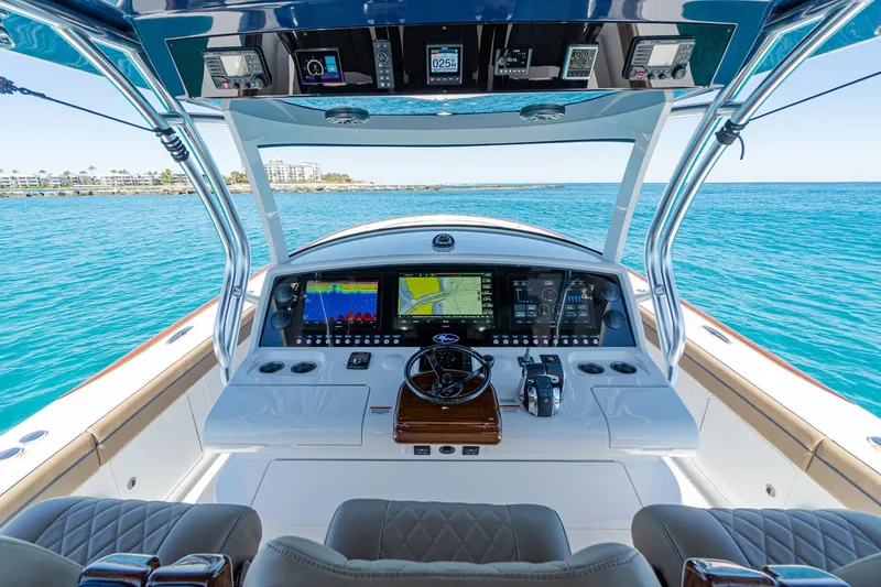 Slide: The Image of 2026 Valhalla Boatworks V-46 helm with advanced navigation systems on open water. - 14