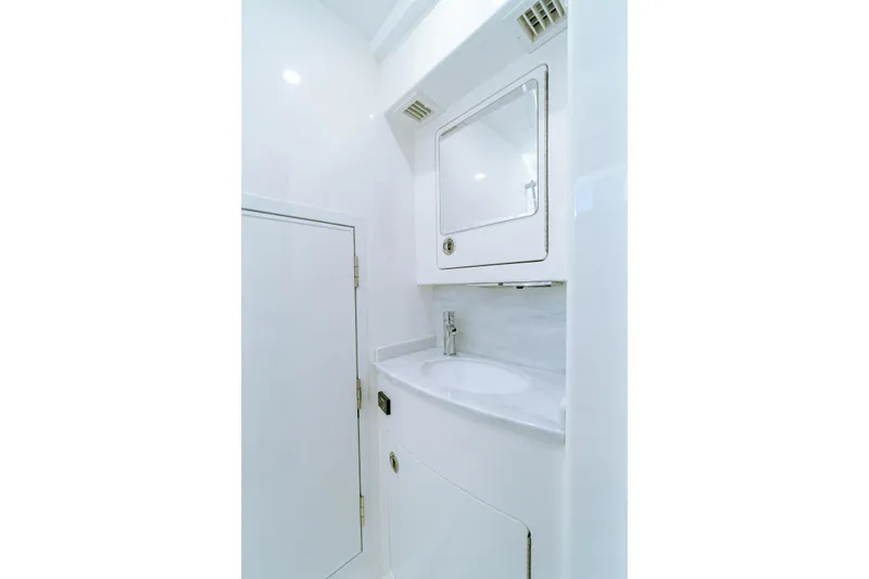 Slide: The Image of 2026 Valhalla Boatworks V-46 bathroom with sleek white design and modern fixtures. - 28
