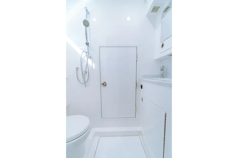 Slide: The Image of 2026 Valhalla Boatworks V-46 bathroom with shower, sink, and toilet in sleek white design. - 30