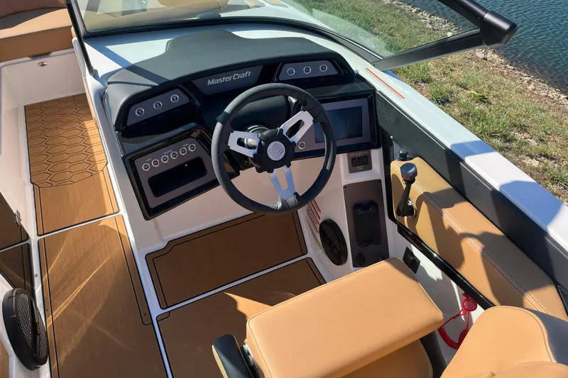 Slide: The Image of 2025 MasterCraft NXT23 boat interior with modern dashboard and steering wheel. - 7