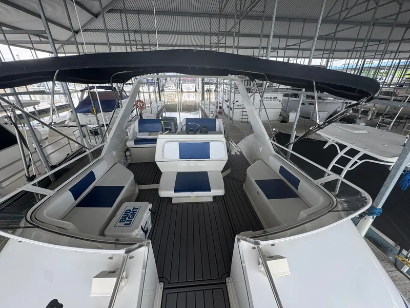 Slide: The Image of 1997 Carver 380 Santego yacht interior with blue and white seating under a canopy. - 10